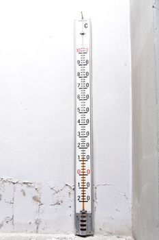 Old thermometer on an old wall