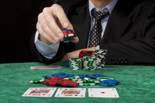 A businessman placing a bet in a Texas hold 'em poker game.