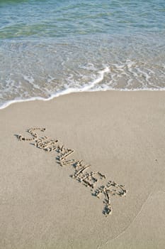 Summer, written on the sand.