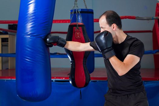 Boxer punching a sand bag with front hand