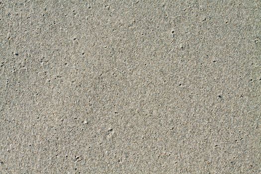 Close up of wet sand ideal for backgrounds and compositions.
