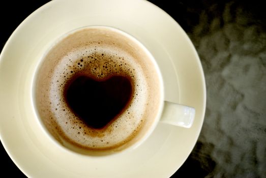 Heart shape inside hot coffee cup