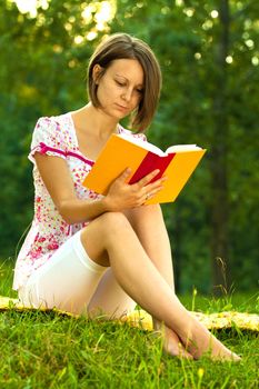 Beautiful woman immersed in a romantic book