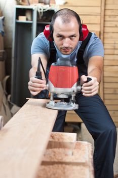 Man working with a router, vertical shot with copy space