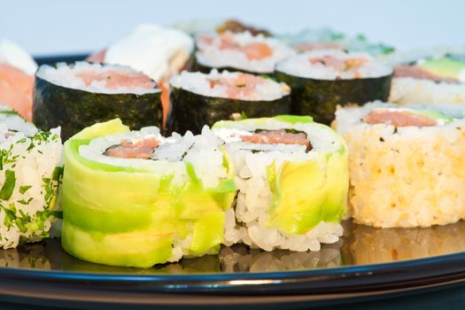 Close up of Sushi in a black plate, horizontal