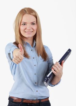 Portrait of an optimistic student blonde girl with her right thumb up and holding a folder in her left hand.The focus is on the eyes.