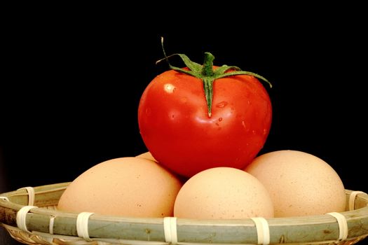 easter preparation - unpainted eggs in a trellis basket on dark background