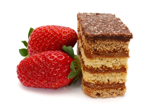 two strawberries and a piece of cake isolated on white background