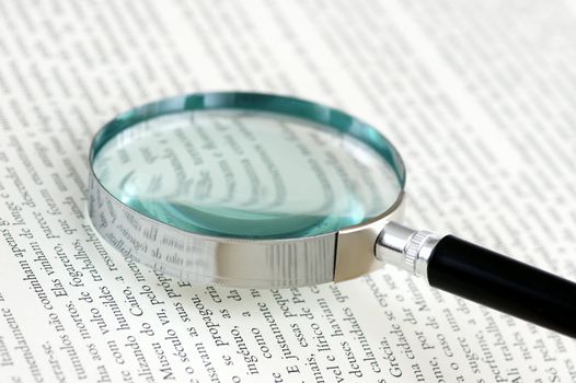 A magnifying glass over a page of a book