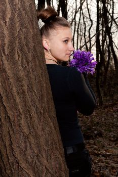 beautiful girl with snowdrops in a forest