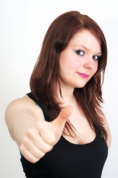 Young woman dressed in black is showing thumb up gesture