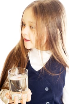 little girl with long hair holding a glass of water