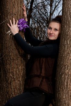 beautiful girl with snowdrops in a forest