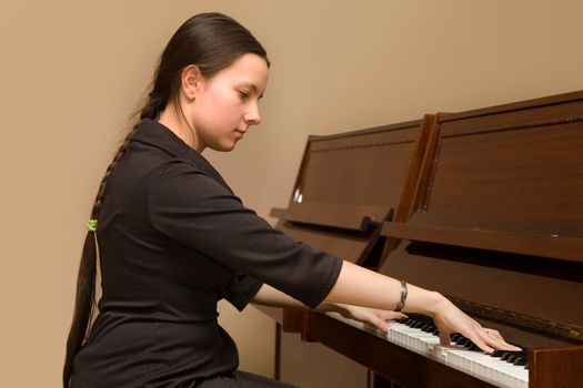 
The girl playing the piano at the music school's office
