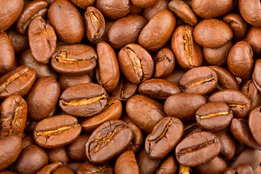 Roasted coffee beans extreme closeup background 