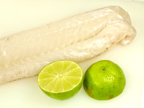 Raw white fish fillet, with lime fruit