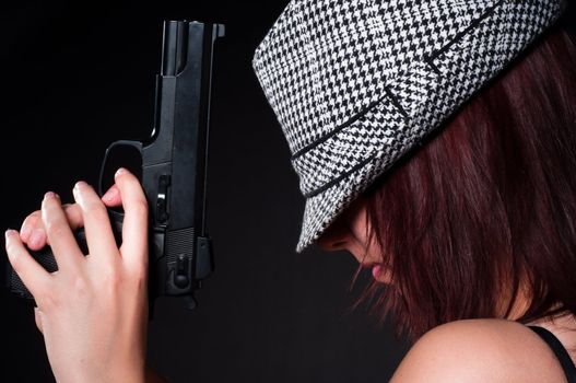 Girl in hat with a big pistol