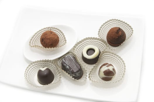 a collection of delicious chocolates on a white plate
