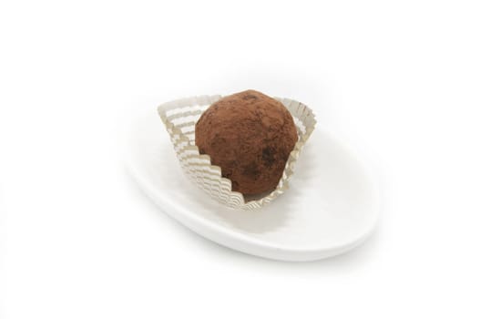 truffle candy on a white plate on white background
