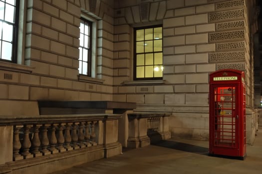 Red telephone box by night