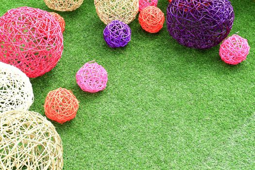 color rattan ball on green grass.