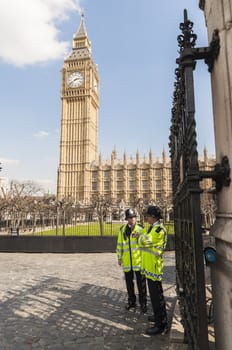 LONDON, UK - APRIL 02: Two policemen guard the front entrance to the Houses of Parliament, with Big Ben prominent in the picture. April 02, 2012 in London.