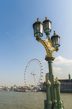 LONDON, UK - APRIL 02: Decorated light post on Westminster Bridge, with London Eye in the background . April 02, 2012 in London.
