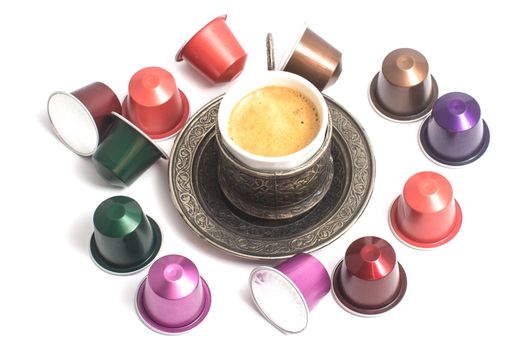 delicious coffee capsules around coffee cup