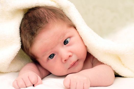 portrait of a smiling baby in a fabric