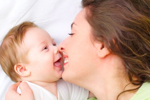 Mother keeps son in his hands.