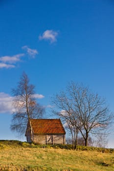 Picture of a small house on the top of a hill