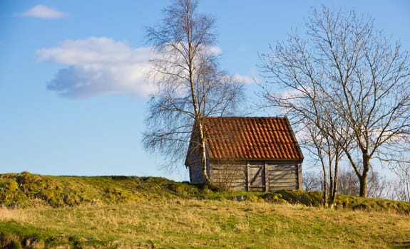 Picture of a small house on the top of a hill