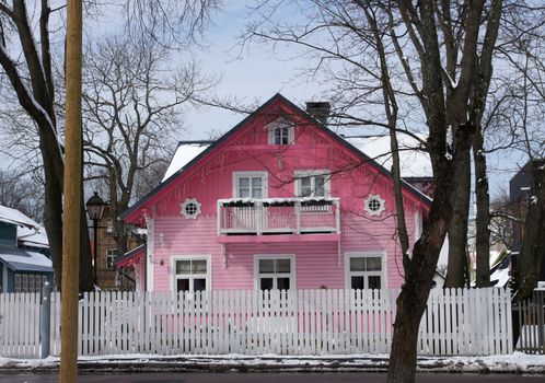 The two-storeyed wooden house is in the street of small city