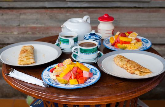 Breakfast with pancakes and fresh fruits In Ubud