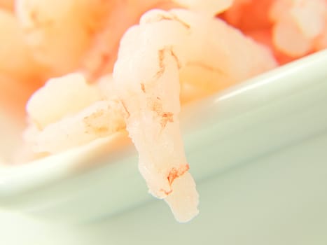 Peeled shrimps, isolated in a white bowl