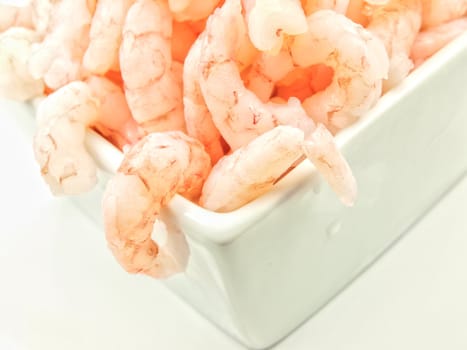 Peeled shrimps, isolated in a white bowl