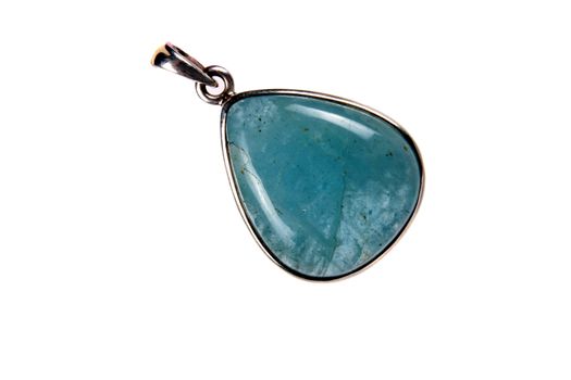 A beautiful aquamarine pendant used as jewelery as well as alternative healing crystal in astrology, isolated on white studio background.