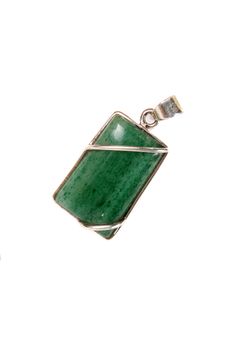 A green jade pendant used in crystal healings and astrology for alternative healings, isolated on white studio background.