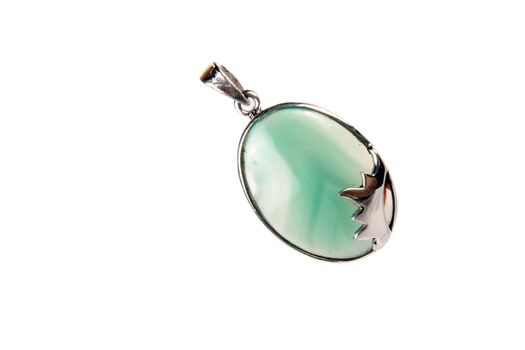 A green onyx pendant used as a jewelery item or for alternative healing methods like crystal healing and astrology, isolated on white studio background.