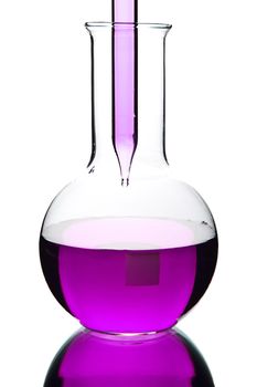 liquid dripping from pipette into flask isolated 