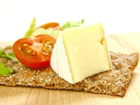 Cracker with cheese and tomato