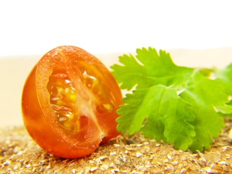 Tomato on cracker with parsley leaf