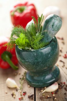 mortar with fresh herbs 