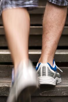 legs of running man on stairs 