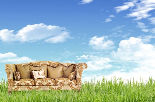 Green grass, blue sky and a sofa