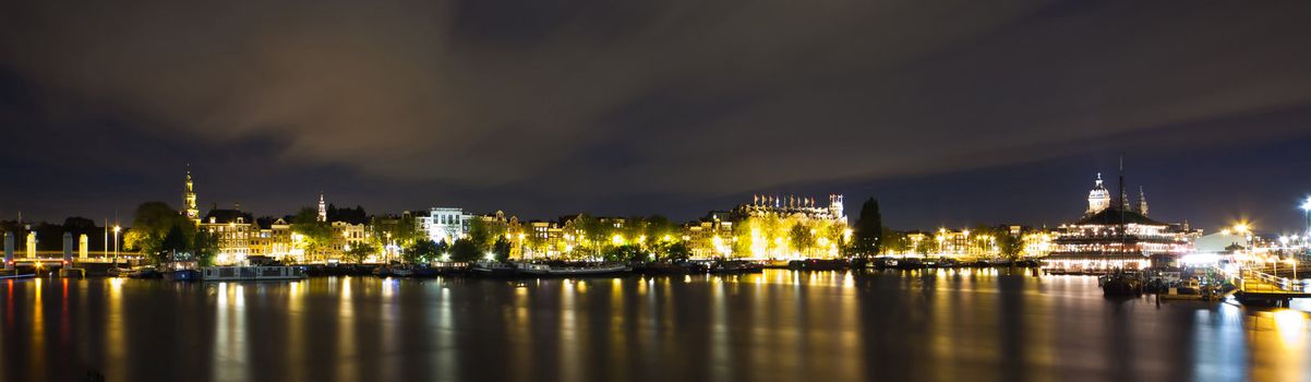 Amsterdam night panorama - view on Sea Palace, Church of St. Nicholas and Grand Hotel Amrath - long time exposure