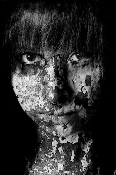 Dark art portrait of a girl with cracks and old paint in black and white