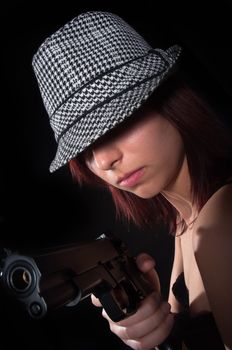 Girl with hat pointing gun