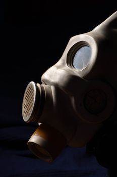 Closeup of a gasmask with blue dark background