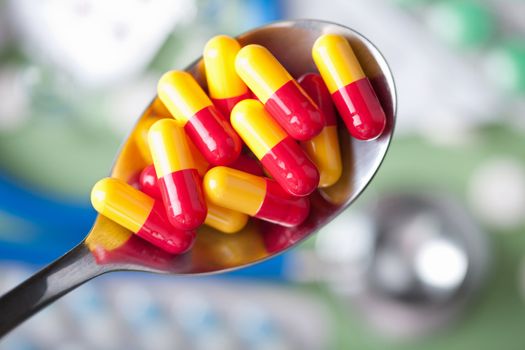 capsule pills in spoon 